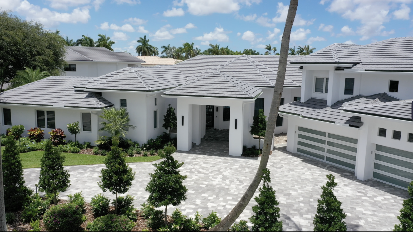 White custom home with tile roof and paver driveway built by All State Contracting